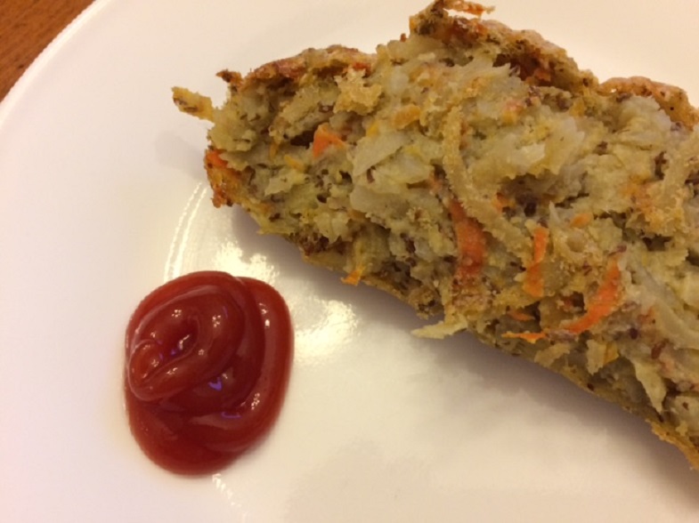 a slice of carrot and potato loaf with ketchup